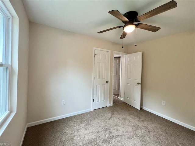 unfurnished bedroom featuring ceiling fan and carpet floors