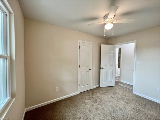 unfurnished bedroom featuring ceiling fan and light carpet