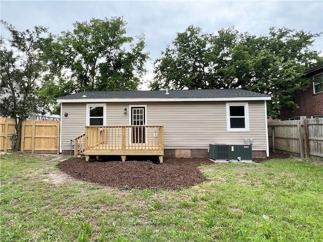 back of house with a lawn, central AC, and a deck