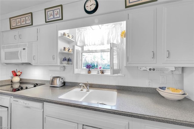 kitchen featuring backsplash, white cabinetry, white appliances, and sink