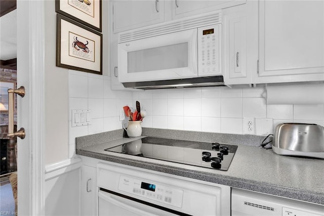 kitchen featuring electric cooktop, white cabinetry, oven, and decorative backsplash