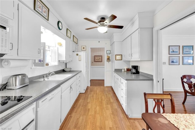 kitchen with white dishwasher and white cabinets