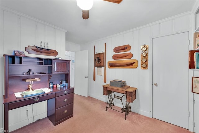 carpeted office space featuring ceiling fan and crown molding