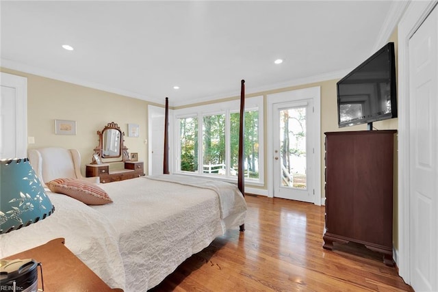 bedroom featuring access to exterior, light hardwood / wood-style floors, and ornamental molding