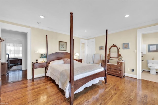 bedroom with light wood-type flooring, ensuite bathroom, and ornamental molding