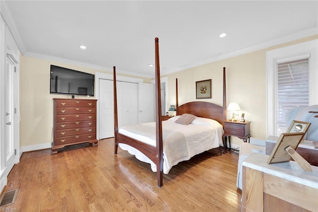 bedroom with light wood-type flooring, a closet, and ornamental molding