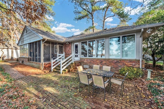 rear view of house with a patio and a sunroom