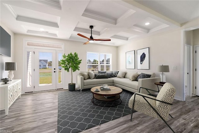 living room featuring hardwood / wood-style flooring, ceiling fan, beam ceiling, and coffered ceiling