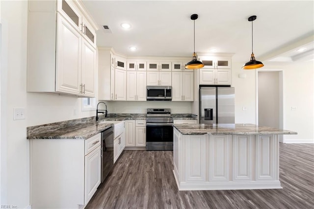 kitchen featuring pendant lighting, white cabinetry, a center island, and stainless steel appliances