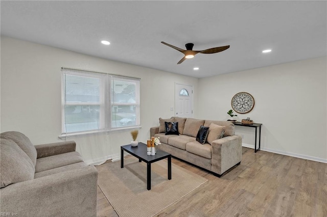 living room featuring ceiling fan and light hardwood / wood-style flooring