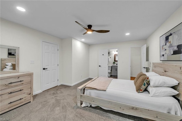 carpeted bedroom featuring ensuite bath and ceiling fan