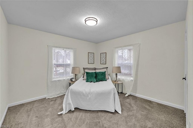 carpeted bedroom featuring a textured ceiling