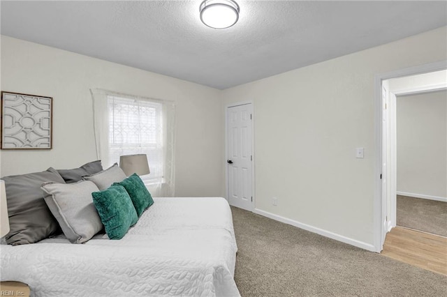 carpeted bedroom with a textured ceiling