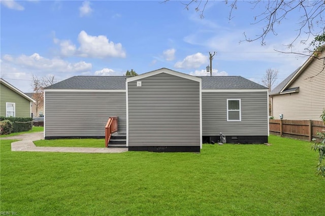 rear view of house with a yard