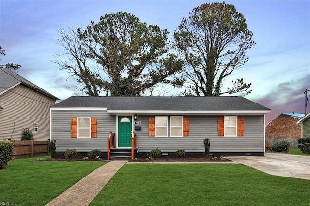 ranch-style home with a lawn