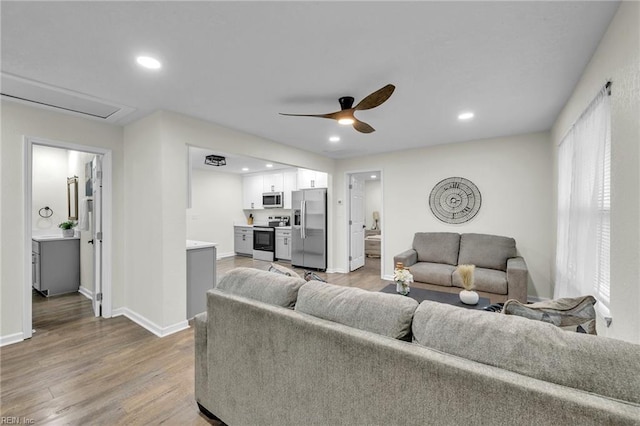 living room with wood-type flooring and ceiling fan