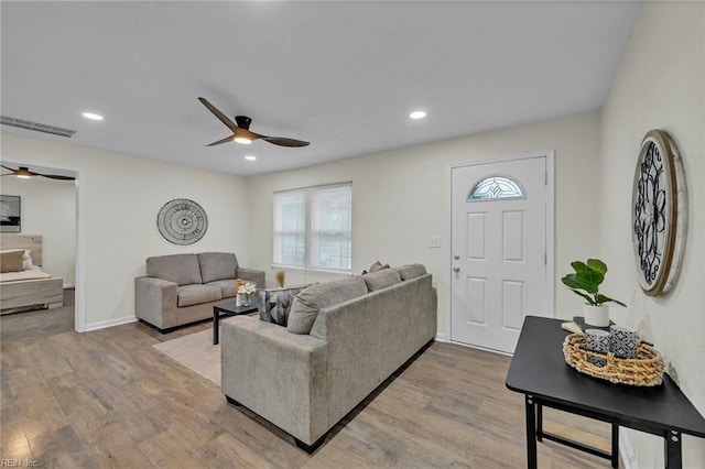 living room featuring ceiling fan and light wood-type flooring