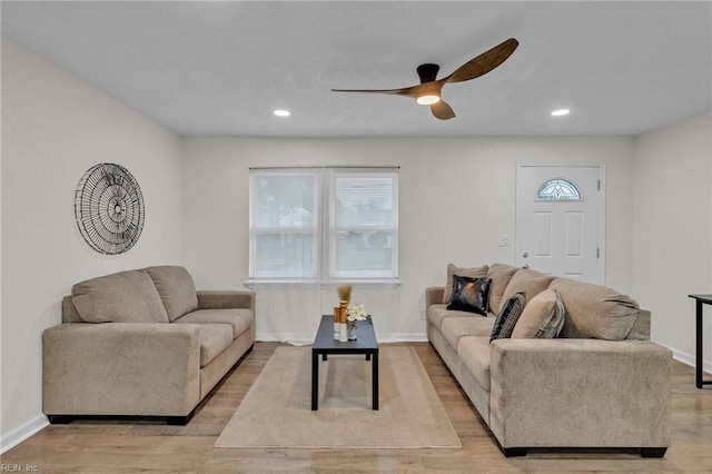 living room with ceiling fan and light hardwood / wood-style floors