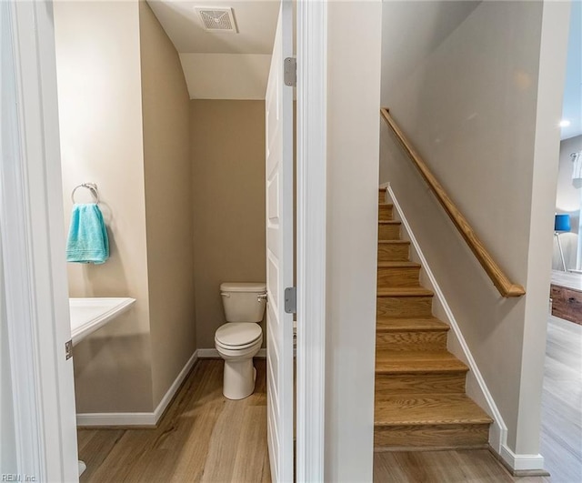 bathroom featuring toilet and hardwood / wood-style flooring