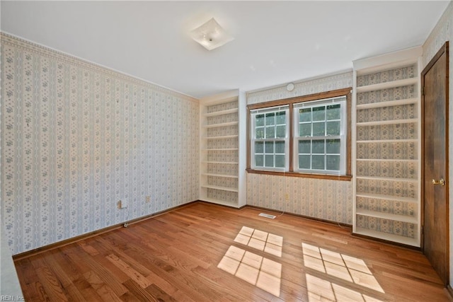 empty room with hardwood / wood-style floors