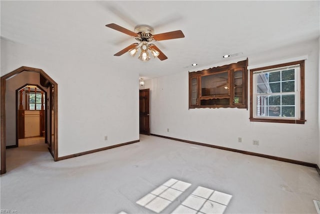 unfurnished room with ceiling fan and light colored carpet