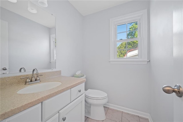 bathroom with tile patterned flooring, vanity, and toilet