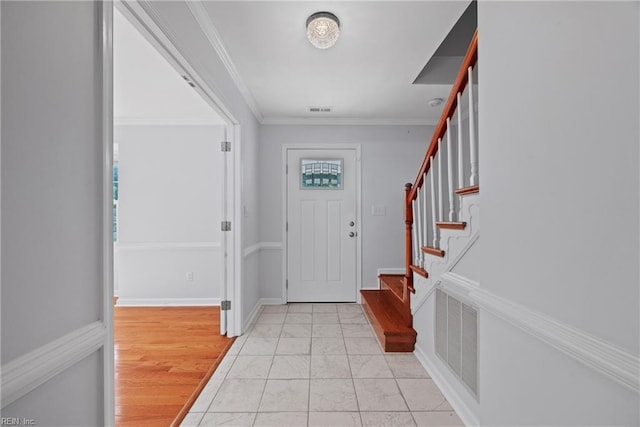 entrance foyer with light wood-type flooring and ornamental molding