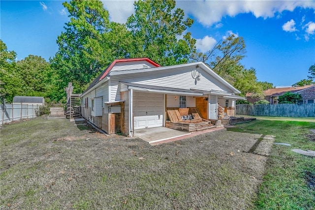 rear view of house featuring a yard and a garage