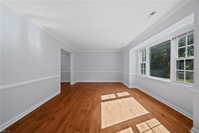 unfurnished room featuring wood-type flooring and crown molding