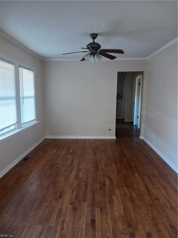 empty room featuring dark hardwood / wood-style floors, ceiling fan, and crown molding