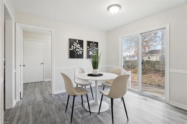 dining room with wood-type flooring