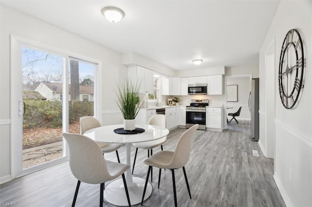 dining area featuring light hardwood / wood-style flooring and sink