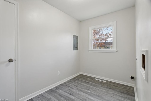 interior space featuring electric panel, a fireplace, and wood-type flooring