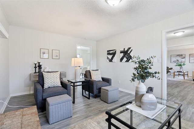 living room with wood-type flooring and a textured ceiling