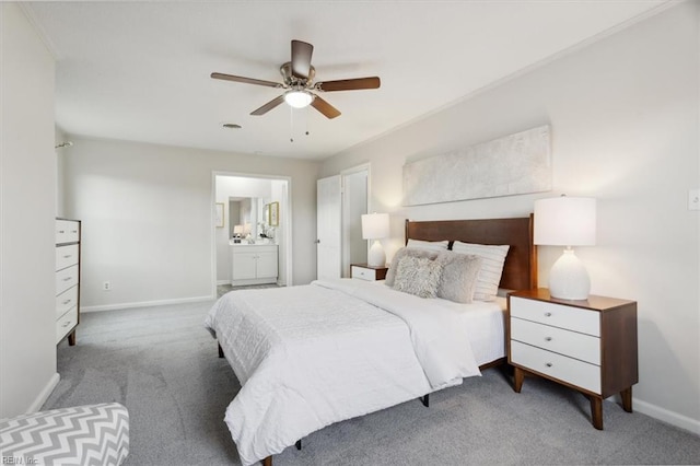 bedroom with connected bathroom, ceiling fan, and carpet floors