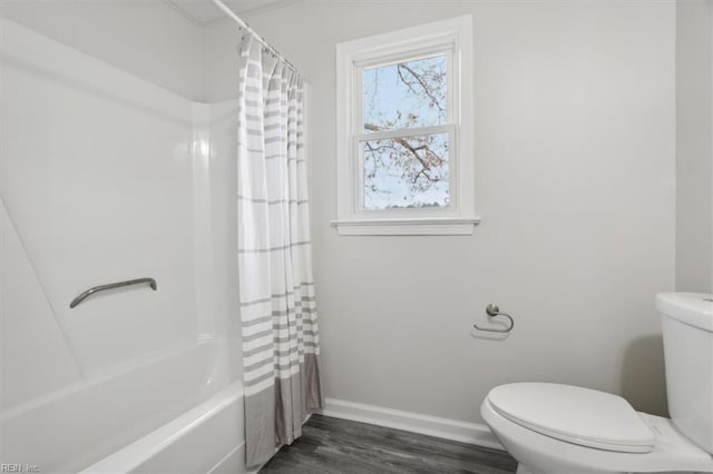 bathroom with hardwood / wood-style flooring, toilet, and shower / bathtub combination with curtain