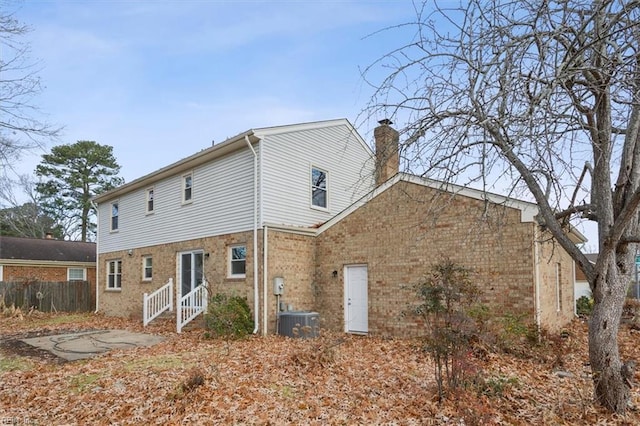 rear view of property featuring a patio and central air condition unit