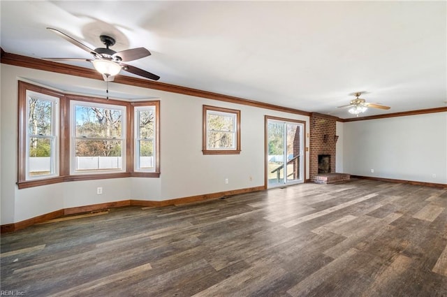 unfurnished living room featuring a brick fireplace, ceiling fan, dark hardwood / wood-style floors, and ornamental molding