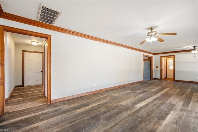 empty room with ceiling fan, dark wood-type flooring, and ornamental molding