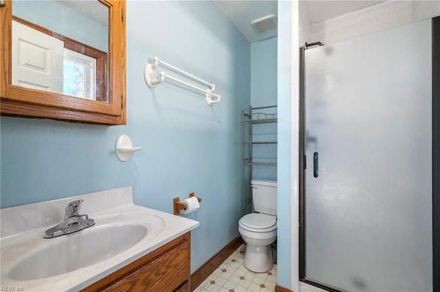 bathroom featuring vanity, toilet, and a shower with shower door