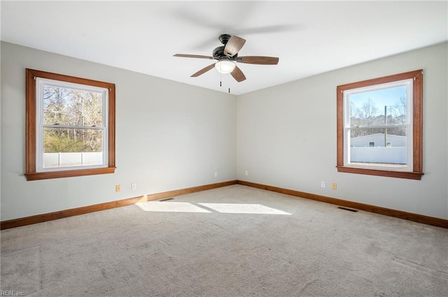 spare room with light carpet and ceiling fan