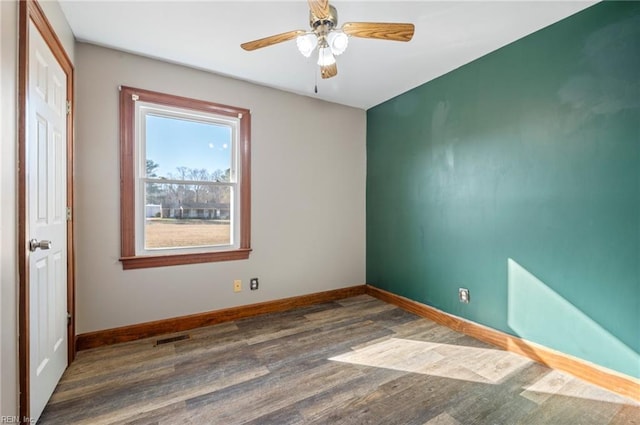 unfurnished room featuring dark hardwood / wood-style flooring and ceiling fan