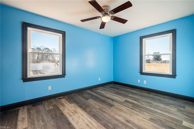 empty room featuring dark hardwood / wood-style floors and ceiling fan