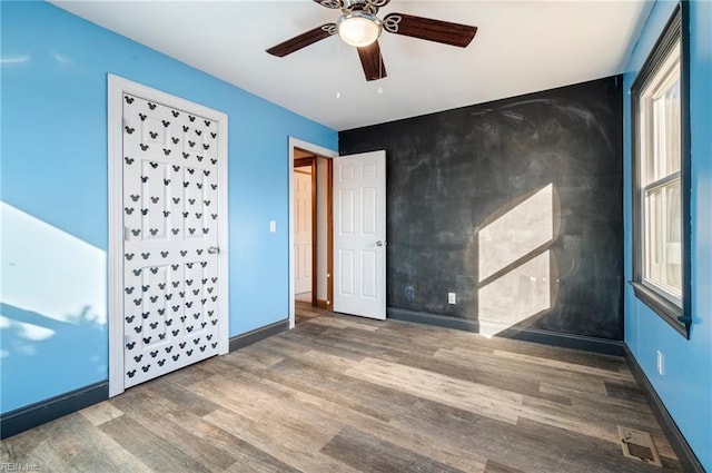 unfurnished bedroom featuring ceiling fan and hardwood / wood-style floors