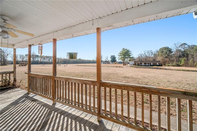 wooden terrace with a rural view and ceiling fan