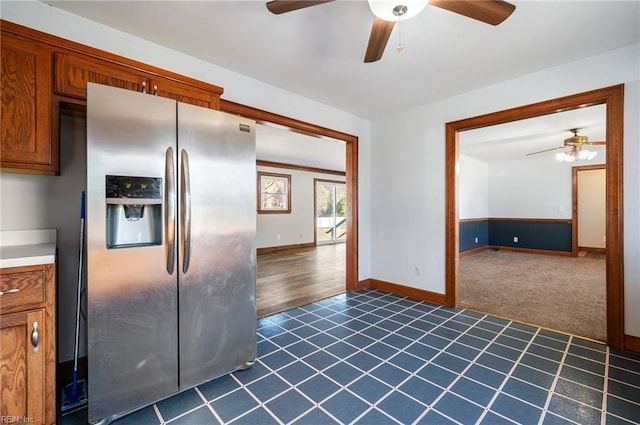 kitchen featuring stainless steel fridge, dark carpet, and ceiling fan