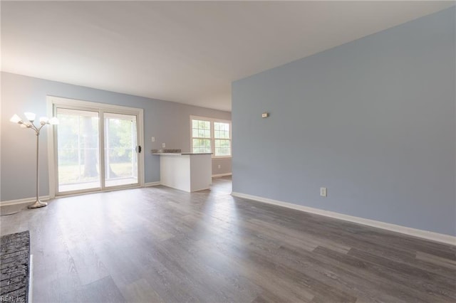 unfurnished living room featuring dark hardwood / wood-style flooring