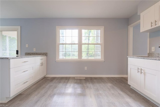 unfurnished dining area with light hardwood / wood-style flooring