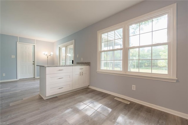 spare room featuring light hardwood / wood-style flooring