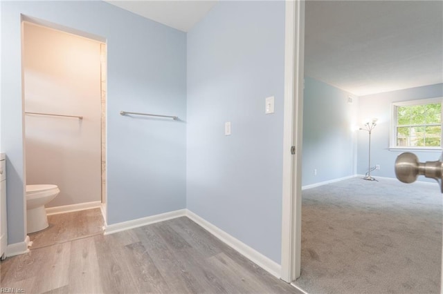 bathroom with hardwood / wood-style floors, vanity, and toilet